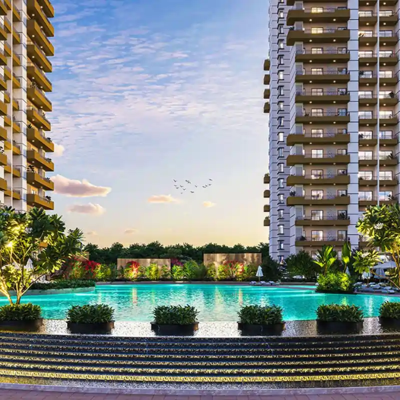 Wave Eden evening view showing residential buildings with landscaped surroundings and water features